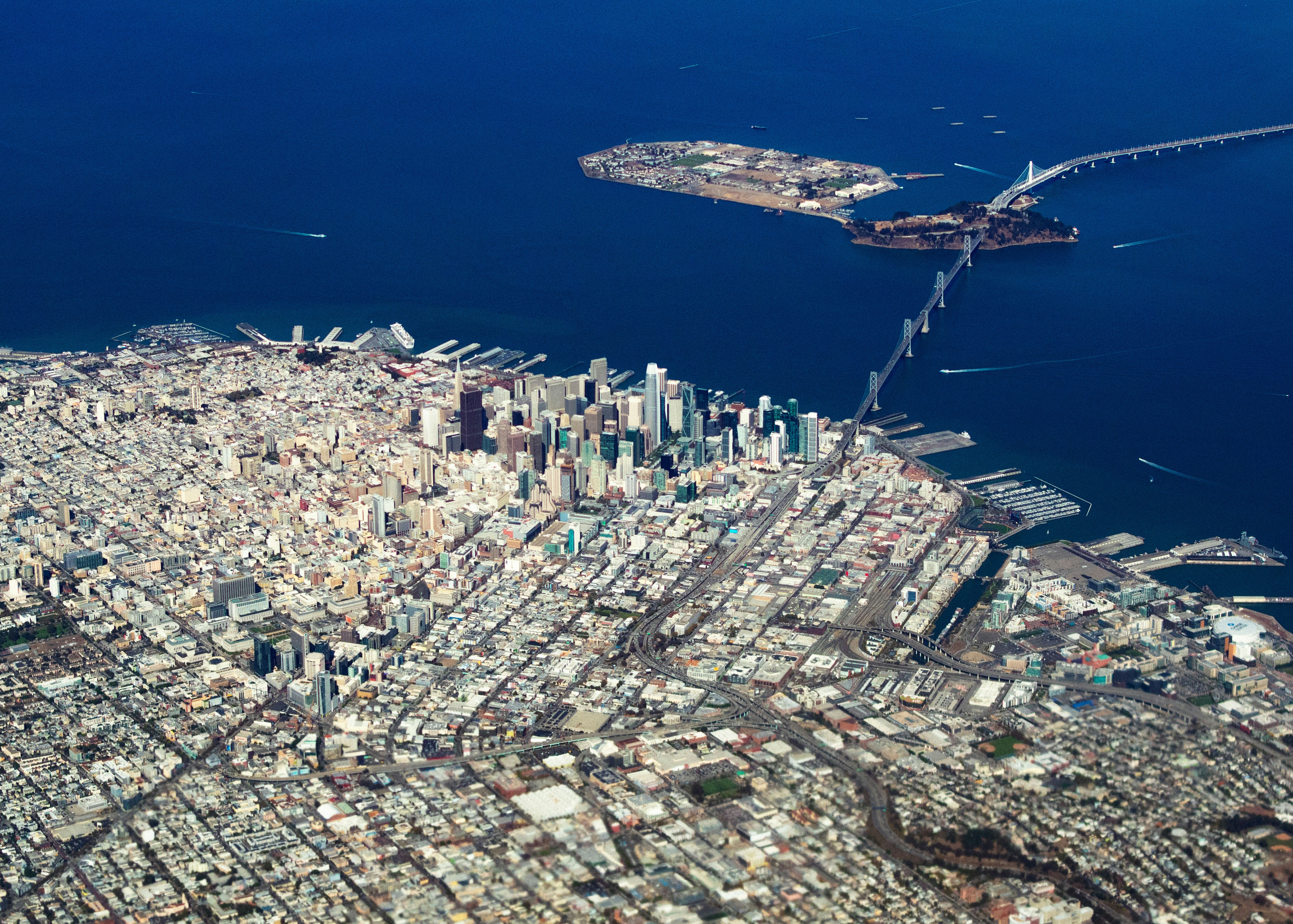 aerial photography of buildings and house viewing blue sea during daytime